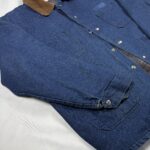 Angled front view of an estimated late 1980s to early 1990s Adolphe Lafont denim work jacket with corduroy collar and patch pockets.