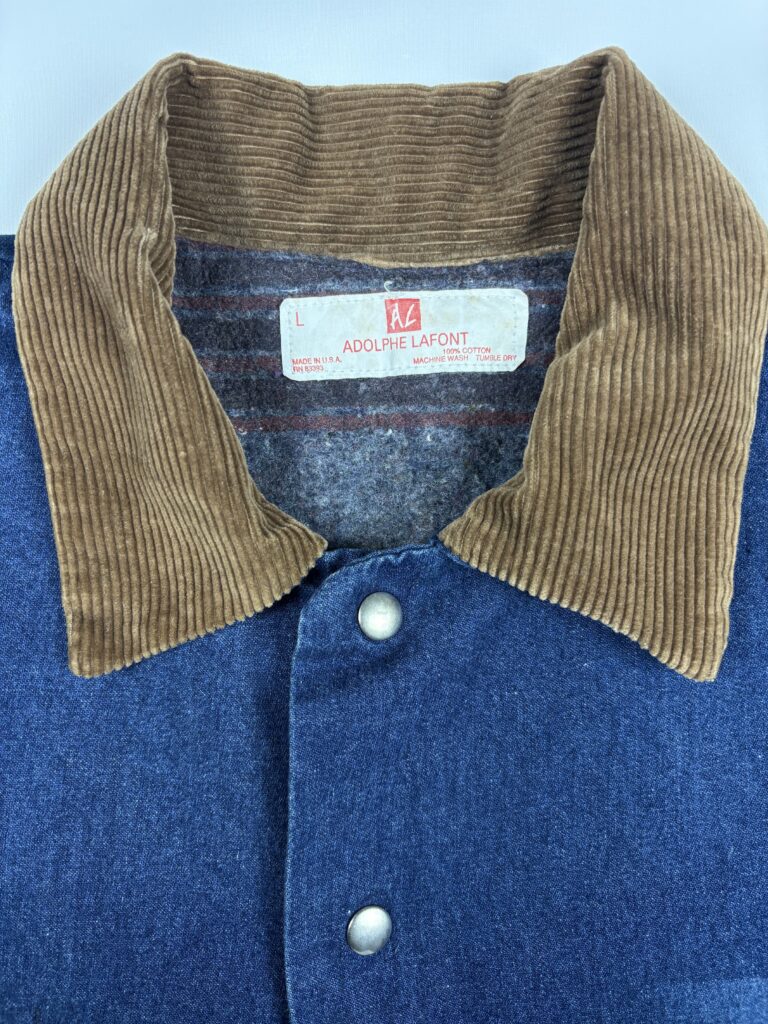 Close-up of the brown corduroy collar and Adolphe Lafont size L label on the USA made vintage denim jacket.